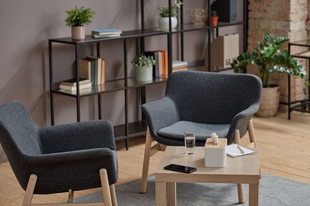 Two chairs and a table in a room.